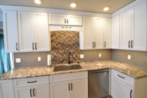 A sleek modern kitchen with a unique backsplash. 