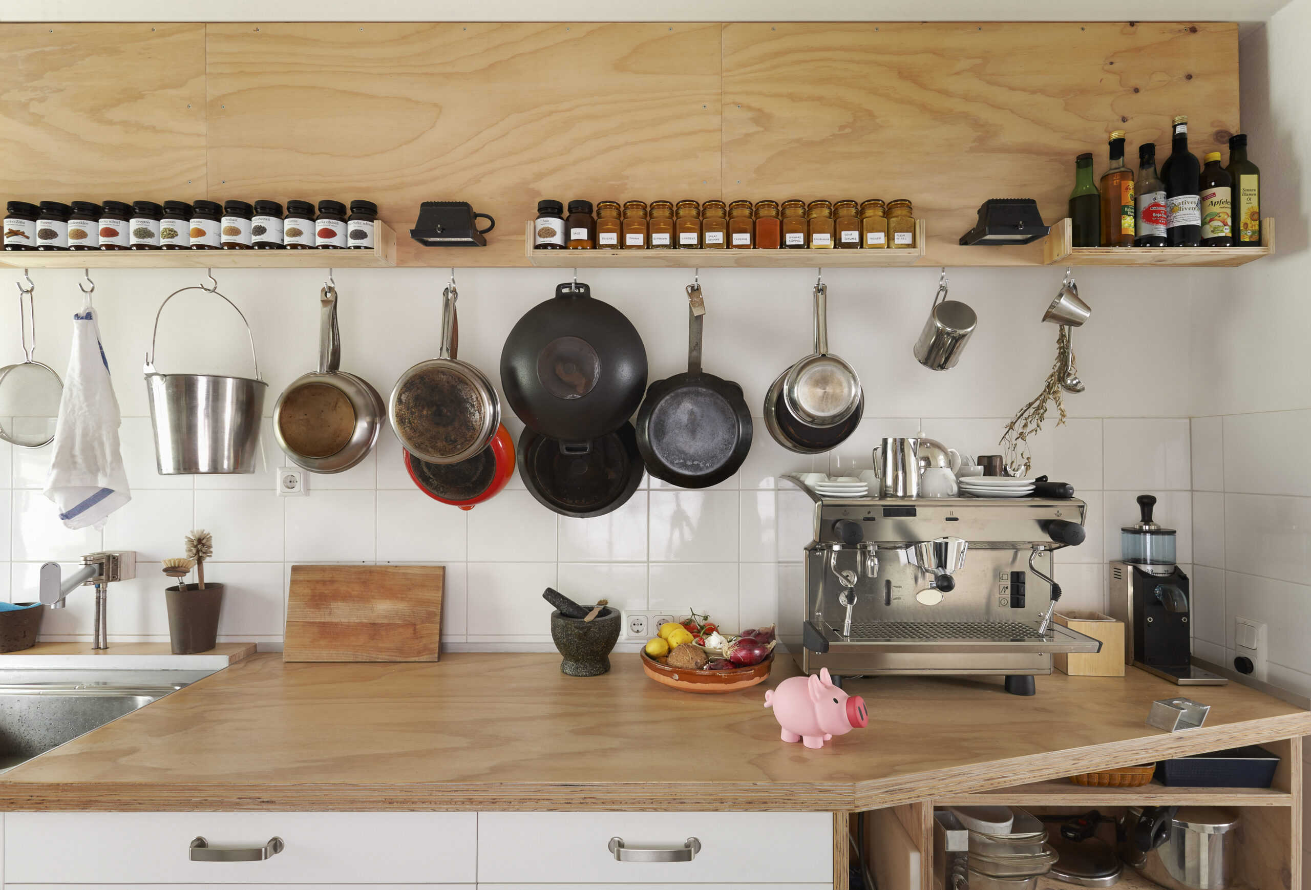 Counter space and cooking utensils in modern kitchen. Corner kitchen optimization.
